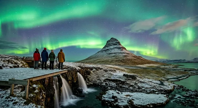 Northern Lights glowing green over a snowy Icelandic landscape near Reykjavik